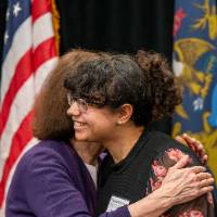 student and dean hugging